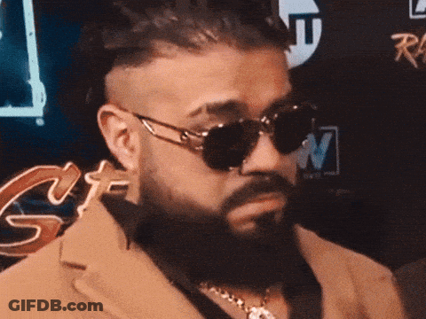A Man Wearing Sunglasses And A Suit Is Being Interviewed By A Man Holding A Microphone That Says Tnt GIF