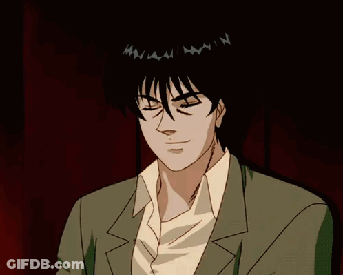 A Man Wearing Sunglasses And A Suit Is Looking At Something GIF