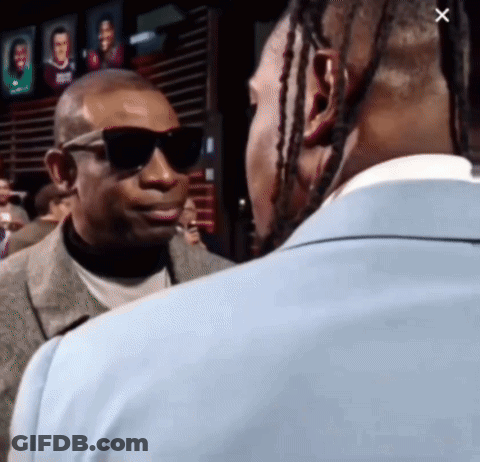 A Man Wearing Sunglasses And A Suit Talks To Another Man GIF