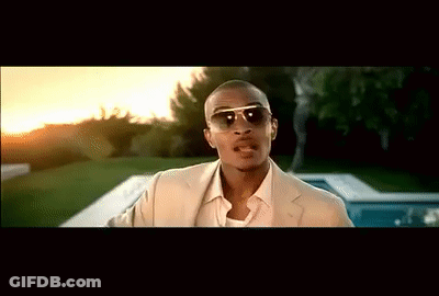 A Man Wearing Sunglasses And A Tan Suit Stands In Front Of A Pool GIF