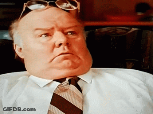 A Man Wearing Sunglasses And A Tie Makes A Serious Face GIF