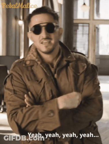 A Man Wearing Sunglasses And A Trench Coat Says Yeah Yeah Yeah Yeah GIF
