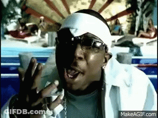 A Man Wearing Sunglasses And A White Headband Is Making A Funny Face GIF
