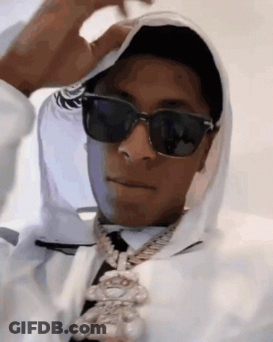 A Man Wearing Sunglasses And A White Hoodie Is Covering His Face . GIF