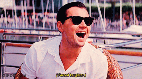 A Man Wearing Sunglasses And A White Shirt Is Laughing With The Words Forced Laughter Below Him GIF