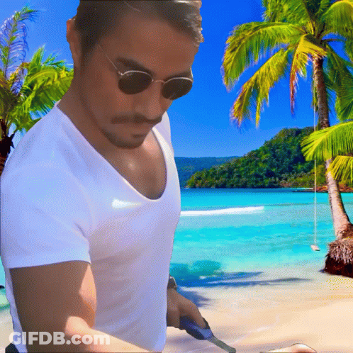 A Man Wearing Sunglasses And A White Shirt Is On A Beach GIF