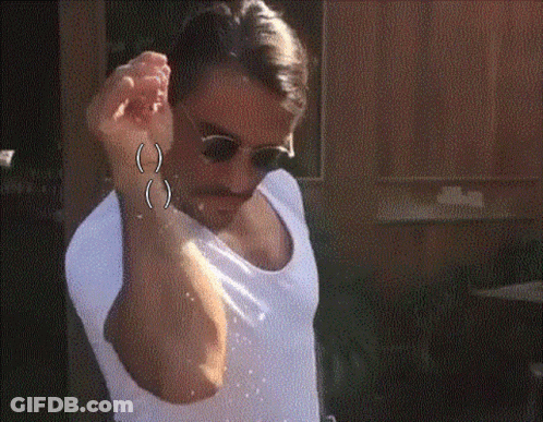 A Man Wearing Sunglasses And A White Shirt Is Sprinkling Salt On His Face . GIF