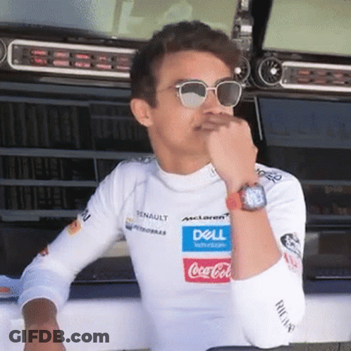 A Man Wearing Sunglasses And A White Shirt With A Dell And Coca Cola Logo On It Is Sitting In A Garage . GIF