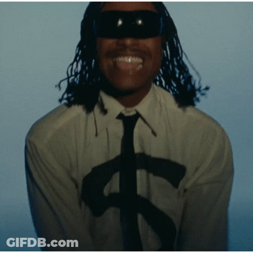 A Man Wearing Sunglasses And A White Shirt With A Dollar Sign On It GIF