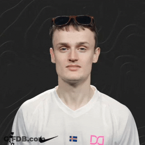 A Man Wearing Sunglasses And A White Shirt With The Letter Dg On It GIF