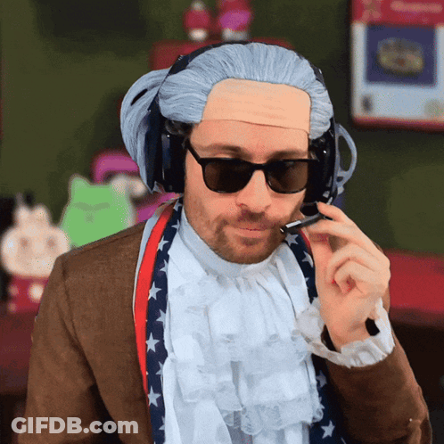 A Man Wearing Sunglasses And A Wig Is Talking On A Phone GIF