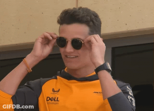 A Man Wearing Sunglasses And An Orange Shirt That Says Dell GIF