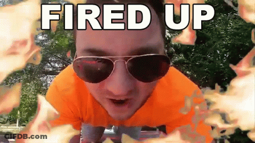 A Man Wearing Sunglasses And An Orange Shirt With The Words Fired Up Behind Him GIF