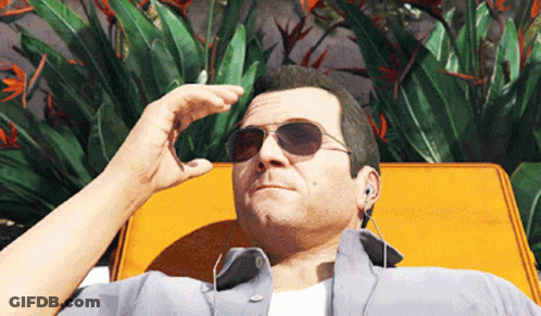 A Man Wearing Sunglasses And Earbuds Is Laying On A Yellow Chair GIF