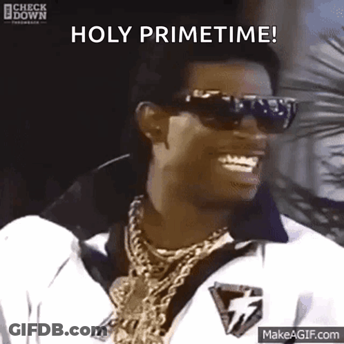 A Man Wearing Sunglasses And Gold Chains Is Smiling And Saying Holy Primetime GIF