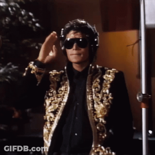 A Man Wearing Sunglasses And Headphones Is Standing Next To A Pole GIF