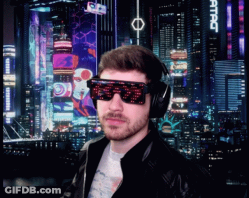 A Man Wearing Sunglasses And Headphones Stands In Front Of A City Skyline With A Sign That Says Attac GIF