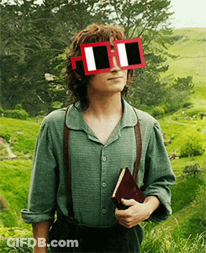 A Man Wearing Sunglasses And Suspenders Holds A Book In His Hand GIF
