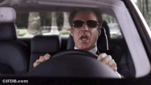 A Man Wearing Sunglasses Driving A Car With His Mouth Open GIF