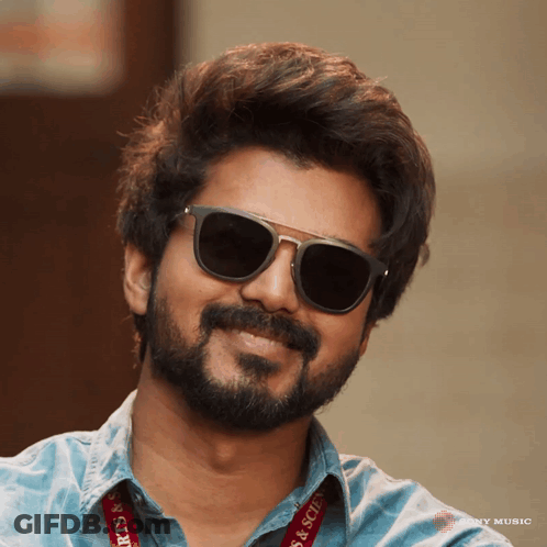 A Man Wearing Sunglasses Has A Lanyard That Says Arts & Science On It GIF