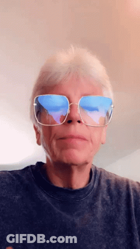 A Man Wearing Sunglasses Has A Reflection Of The Ocean In His Lenses GIF