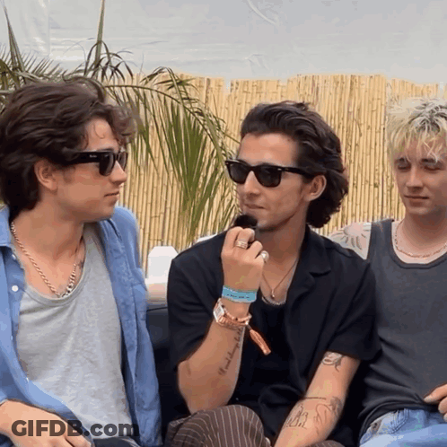 A Man Wearing Sunglasses Has A Tattoo On His Arm That Says " I 'M A Bitch " GIF
