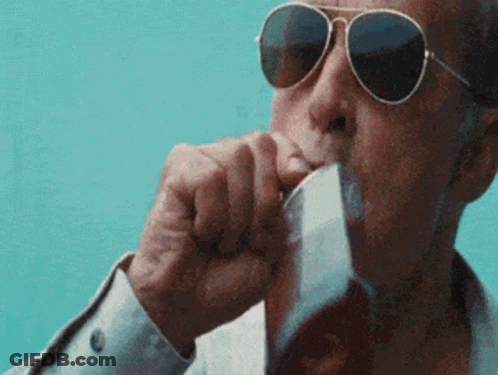 A Man Wearing Sunglasses Is Drinking From A Glass Of Beer . GIF