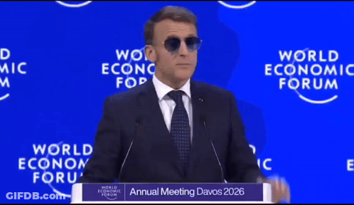 A Man Wearing Sunglasses Is Giving A Speech At The Annual Meeting Of The World Economic Forum GIF