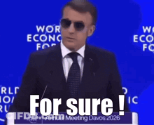 A Man Wearing Sunglasses Is Giving A Speech At The World Economic Forum Annual Meeting GIF