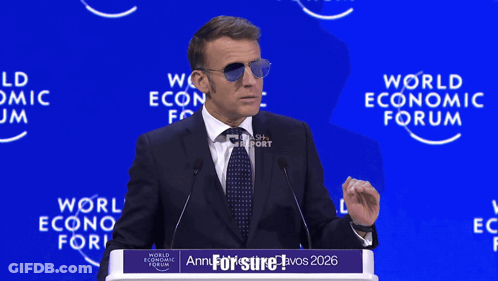 A Man Wearing Sunglasses Is Giving A Speech At The World Economic Forum In 2026 GIF