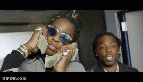 A Man Wearing Sunglasses Is Holding A Bunch Of Money In His Hands . GIF