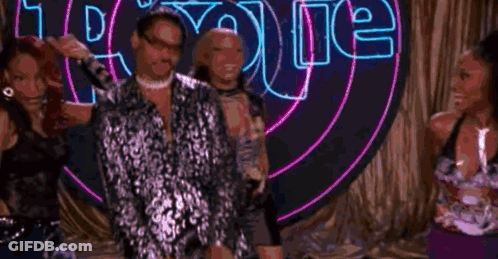 A Man Wearing Sunglasses Is Holding A Woman 'S Hand In A Close Up . GIF