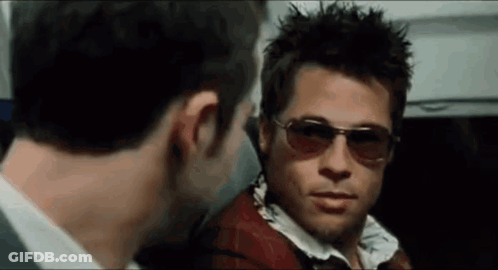 A Man Wearing Sunglasses Is Looking At Another Man GIF