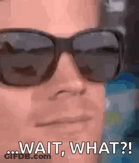 A Man Wearing Sunglasses Is Making A Funny Face . GIF