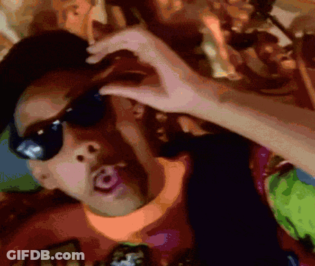 A Man Wearing Sunglasses Is Making A Heart Shape With His Hands GIF