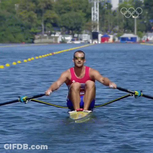 A Man Wearing Sunglasses Is Rowing A Boat In The Water GIF