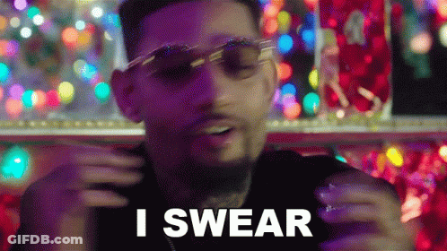 A Man Wearing Sunglasses Is Saying I Swear In Front Of Christmas Lights GIF