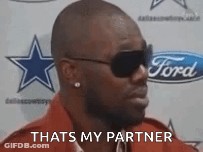 A Man Wearing Sunglasses Is Saying `` That 'S My Partner '' In Front Of A Ford Logo . GIF