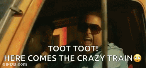 A Man Wearing Sunglasses Is Screaming In A Car With The Words Toot Toot Here Comes The Crazy Train GIF