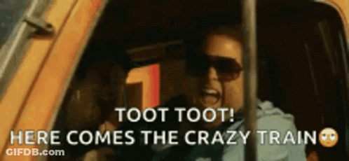 A Man Wearing Sunglasses Is Screaming Out Of A Car Window And Says Toot Toot Here Comes The Crazy Train . GIF