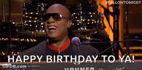 A Man Wearing Sunglasses Is Singing Into A Microphone And Saying `` Happy Birthday To Ya '' . GIF