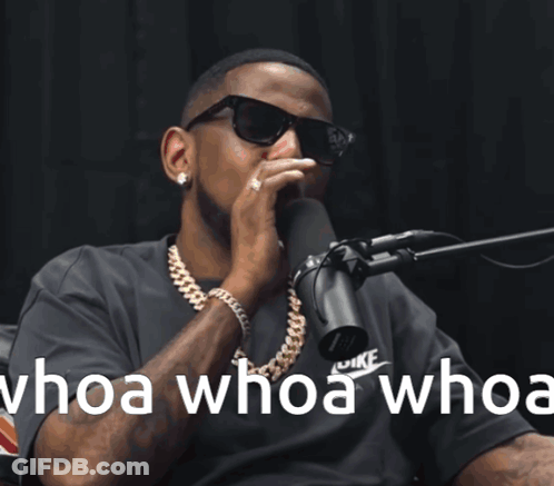 A Man Wearing Sunglasses Is Singing Into A Microphone With The Words Whoa Whoa Whoa GIF