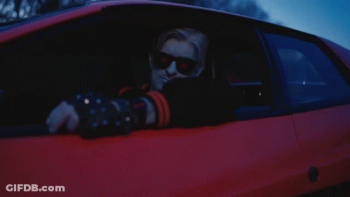 A Man Wearing Sunglasses Is Sitting In A Car GIF