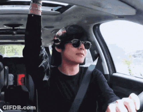 A Man Wearing Sunglasses Is Sitting In A Car GIF