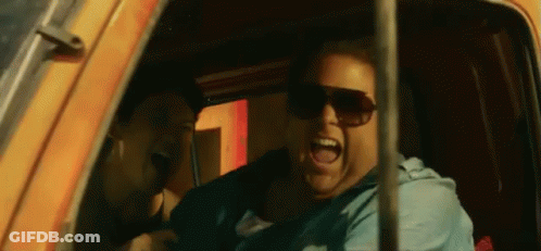 A Man Wearing Sunglasses Is Sitting In A Car And Screaming . GIF