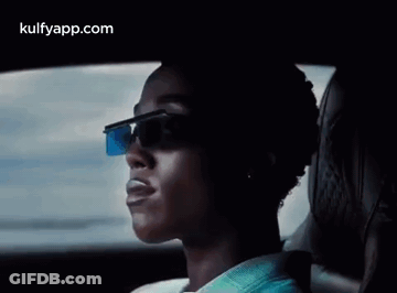 A Man Wearing Sunglasses Is Sitting In A Car . GIF