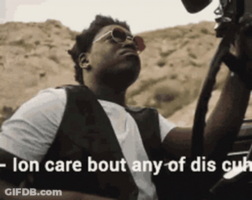A Man Wearing Sunglasses Is Sitting In A Car With The Words " Ion Care Bout Any Of Dis Cu " Written Below Him GIF