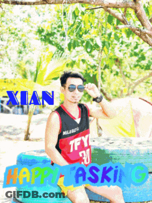 A Man Wearing Sunglasses Is Sitting On A Tire With The Name Xian Above Him GIF