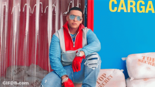 A Man Wearing Sunglasses Is Sitting On Top Of A Pile Of Top Secret Bags GIF