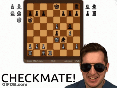A Man Wearing Sunglasses Is Smiling In Front Of A Chess Board That Says Checkmate On It GIF